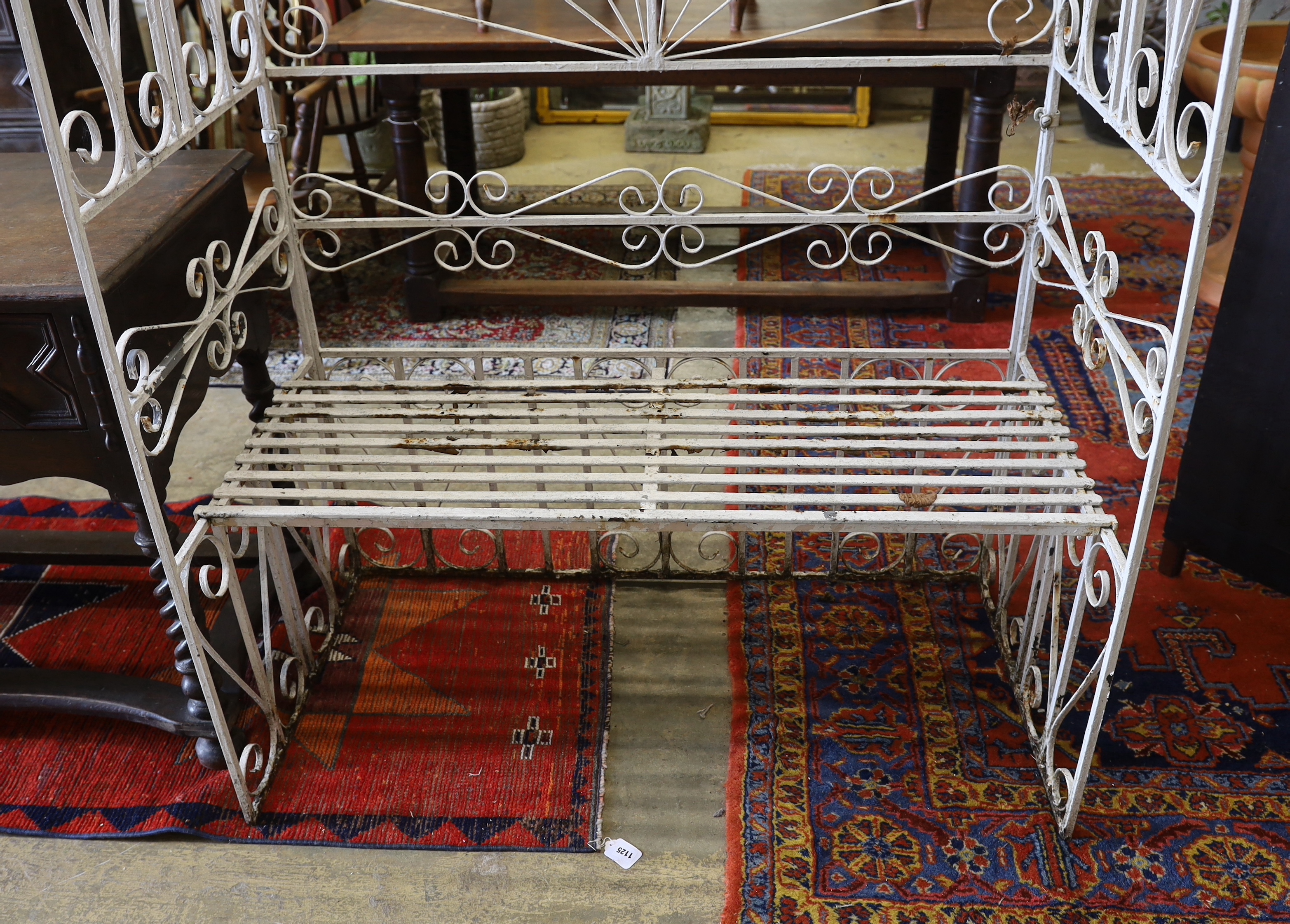 A painted wrought iron rose arbour garden seat, width 120cm, depth 62cm, height 218cm